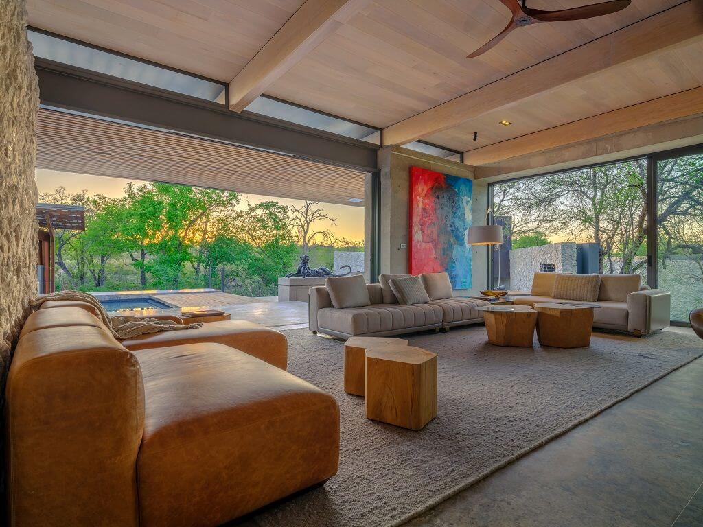 Lounge mit braunen Ledermöbeln und raumhohen Fenstern.