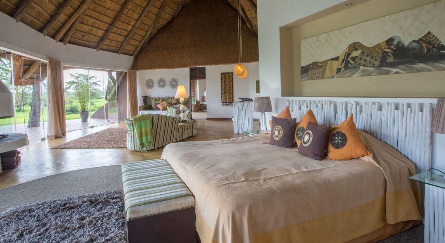 Großes Bett mit vielen Kissen in einem Cottage.