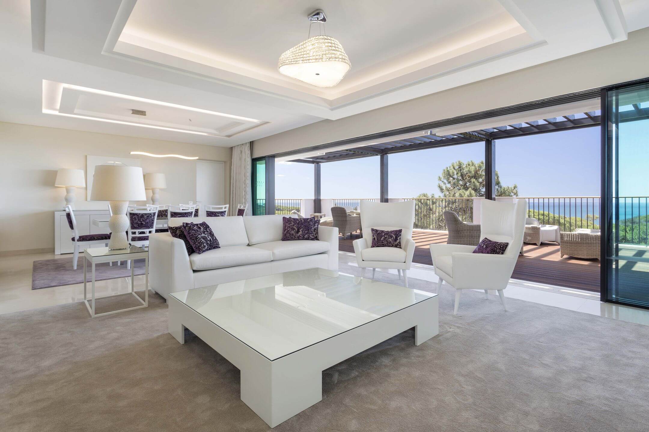 Moderne Luxussuite, clean und weiß, mit großer Fensterfront.