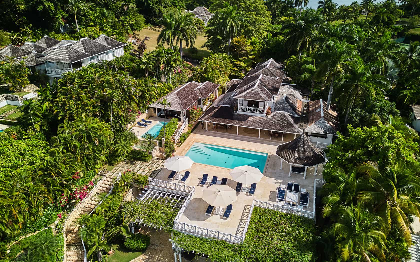round hill hotel and villas Gebäude mit Pool und Liegen